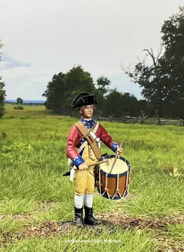 Continental Line Drummer. Person in colonial attire holding a drum in a grassy field with trees in the background