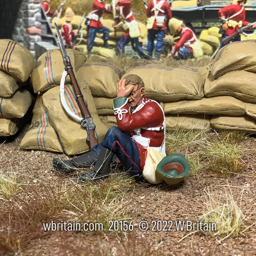 Collectible toy soldier miniature British 24th Foot Seated Wounded. Seated in front of sand bags.