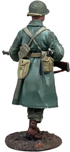 Rear view of toy soldier miniature army men walking in the woods.