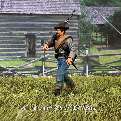 Collectible toy soldier miniature army men Confederate Infantry Marching. He is in a field.