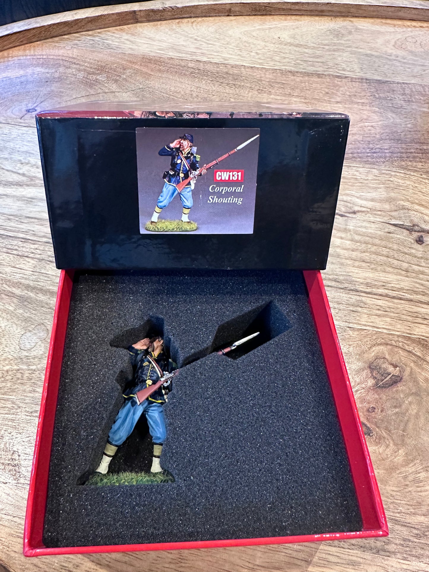 Corporal Shouting presented in a classic red collector box.