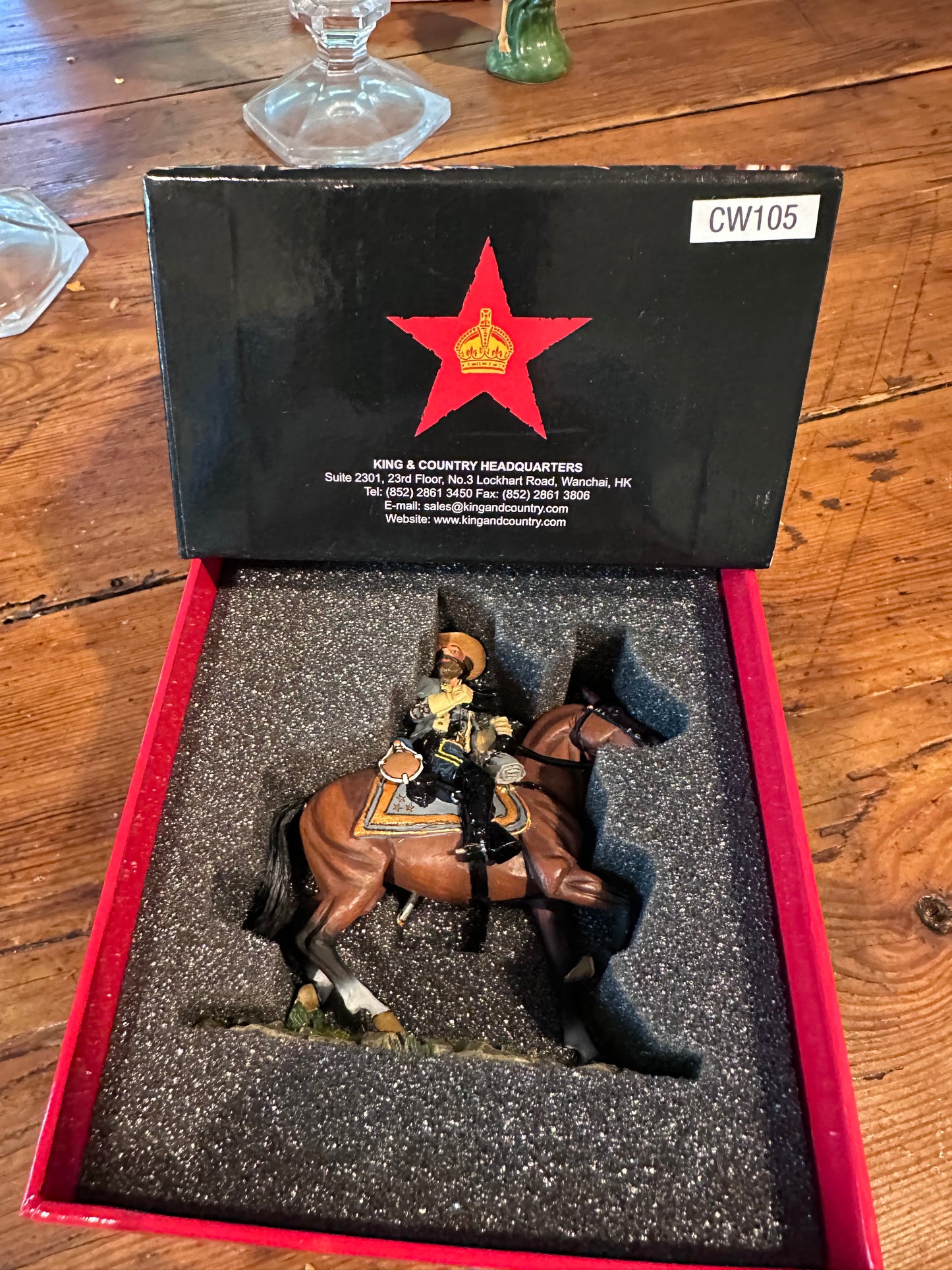 Model figure toy soldier Major General J.E.B. Stuart in a display case with a red star emblem on a wooden surface