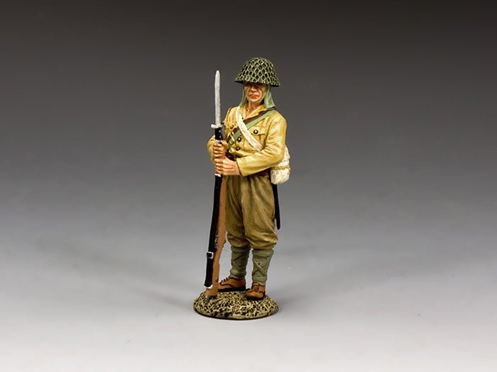 Toy soldier figure in military uniform with rifle on a gray background