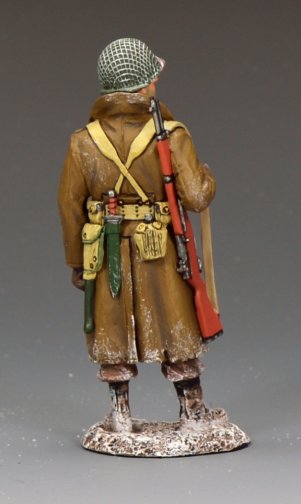Rear view of U.S. GI in winter greatcoat standing guard with rifle, 1/30 scale matte toy soldier.