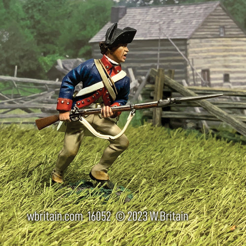Collectible toy soldier miniature continental soldier running in a field with musket and bayonet,