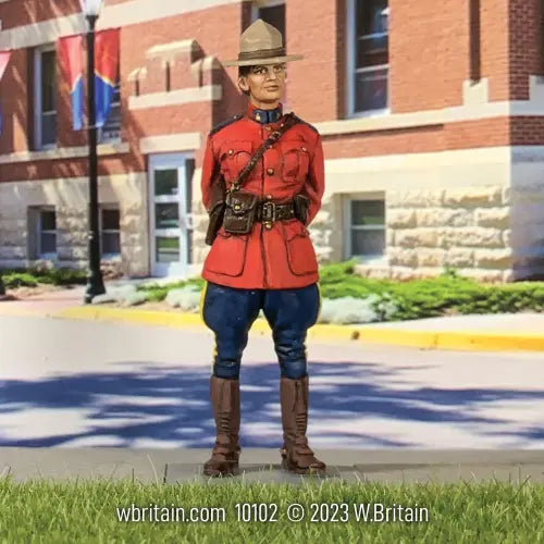 W Britain Royal Canadian Mounted Police Female Trooper 10102 RCMP 1/30 scale matte figure in red serge uniform standing in front of a building