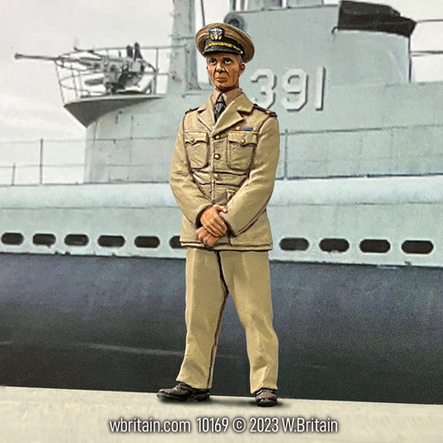 A toy soldier figurine of U.S.N Lieutenant Jimmy Carter standing in front of a naval ship. The figure is dressed in a light khaki uniform with full medals and insignia, holding a cap in his right hand. The background features a gray naval ship with the number '391' prominently displayed. The figurine is detailed, capturing Carter's focused expression and military attire, set against a historically themed backdrop.