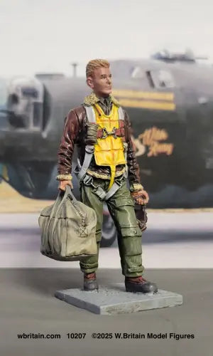 W Britain USAAF bomber crewman 10207 WWII 1/30 scale figure walking with parachute helmet and kit bag in front of plane