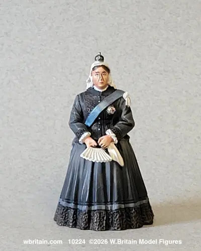 W. Britain 10224 figure of Queen Victoria in a black mourning gown and white widow's cap topped by her small diamond crown, wearing the blue Garter riband.