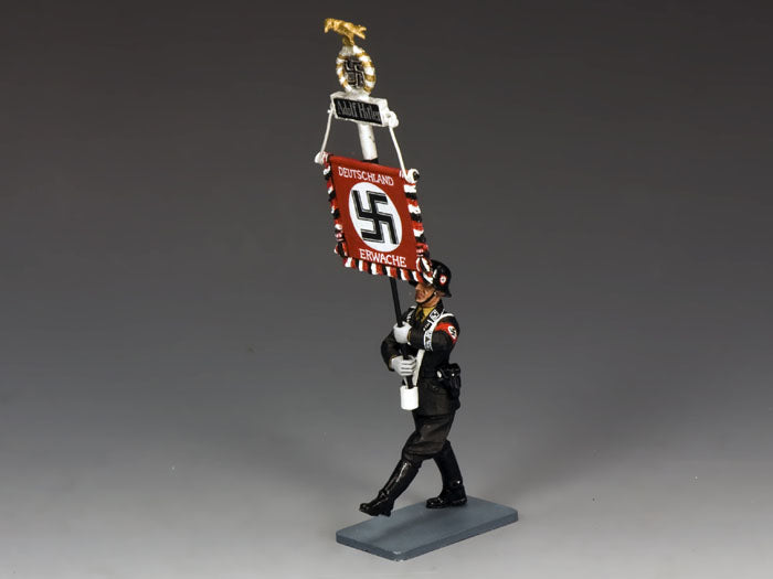 Model figure of a soldier holding a banner with a swastika symbol on a gray background