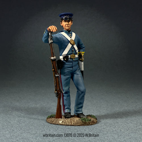 Collectible toy soldier U.S. Marine in fatigue Uniform. He is holding a musket.