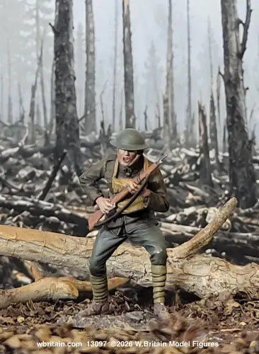 A detailed model figurine of a World War I soldier in a muddy, destroyed forest setting, holding a rifle. The figure is posed on a fallen log with a backdrop of smoky, barren tree trunks.