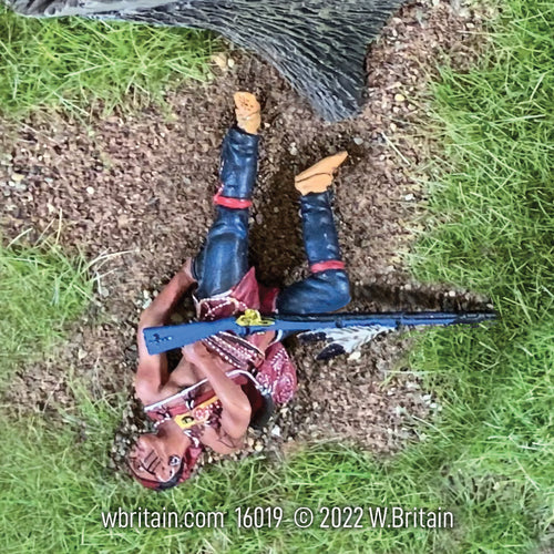 Collectible toy soldier army men Native Warrior Casualty. He is in the grass.