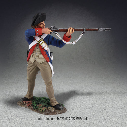 Collectible toy soldier miniature standing aiming musket. Soldier is in blue and white uniform.