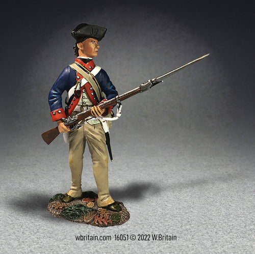 Collectible toy soldier miniature in continental uniform holding musket and bayonet.