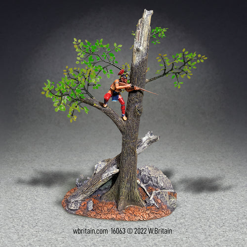 A collectible toy soldier miniature Native warrior firing from a tree.