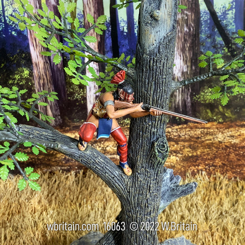 Collectible toy soldier miniature aiming rifle while in a tree.