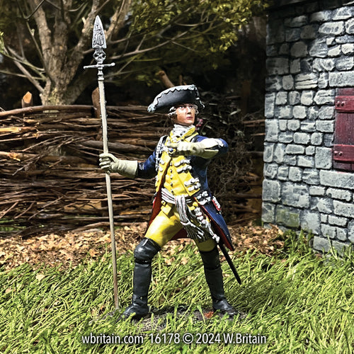 A 1/30 scale toy soldier figurine depicting a Hessian Leib Infantry Regiment Officer from 1776, standing in a dramatic pose with a spear.