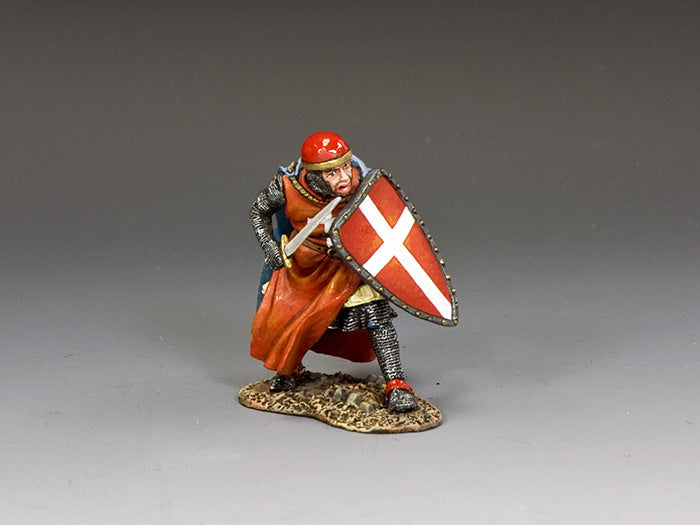 Miniature figurine of a knight holding a shield with a white cross on a gray background