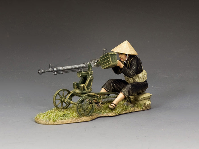 Toy soldier of a female Viet Cong gunner in black clothing and conical hat operating a DShK 12.7mm heavy machine gun on wheeled mount.