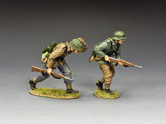 Two miniature figures of soldiers in military uniforms with rifles on a gray background