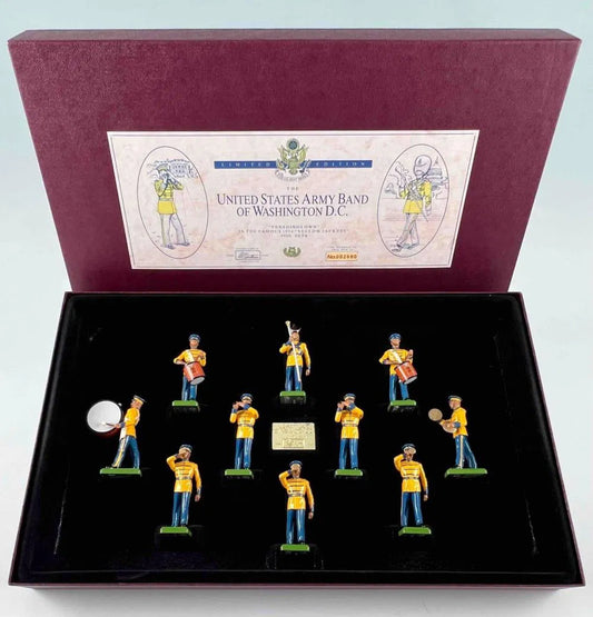 Box set of miniature figurines of the United States Army Band of Washington D.C. The open case shows 11 figures in yellow and blue uniforms, each holding different instruments. The box lid has an illustrated label with text.