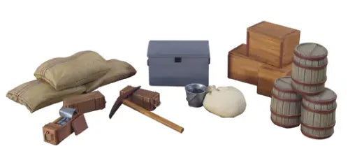 Collection of model train accessories including boxes, barrels, and tools on a white background