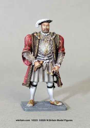 W. Britain 10223 figure of Henry VIII standing square in a fur-lined crimson gown, jewelled collar and plumed bonnet, one hand resting near his dagger.