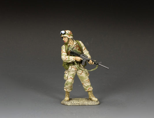 Desert-uniformed toy soldier Ranger turns with M16A2 at the ready, guarding the rear .
