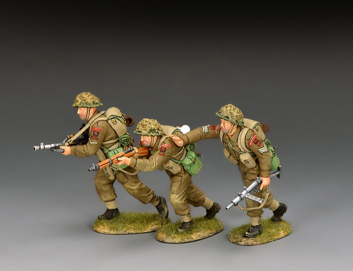King & Country DD397 set of three British infantry advancing — a Sten-armed sergeant urging on a rushing rifleman and a Bren-gunning lance corporal, in battledress and scrim-netted helmets.