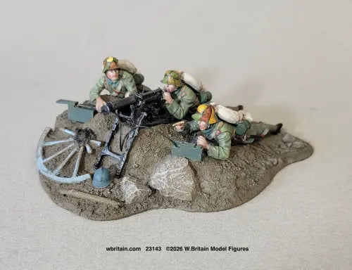 W Britain 23143 The Devil's Paint Brush German Infantryman Team with MG08 1916-18 1/30 scale matte three-figure set — gunner at the spade grips of an MG08 on its sledge mount with two loaders and ammunition boxes, all in camouflaged Stahlhelms, on a rocky groundwork base.