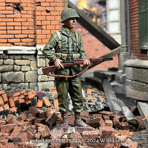 Collectible toy soldier miniature army men U.S. Infantryman with M1 Garand. He is standing in the ruins.