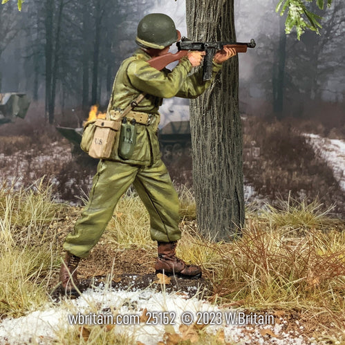 Toy soldier army man U.S. Infantryman Standing, Firing Thompson From Shoulder. He is in the forest.