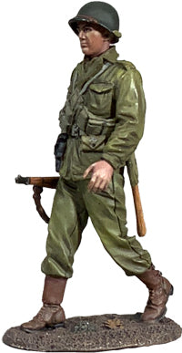 Side view of Collectible toy soldier miniature army men U.S. Infantryman Walking figurine. He is wearing an olive color uniform.