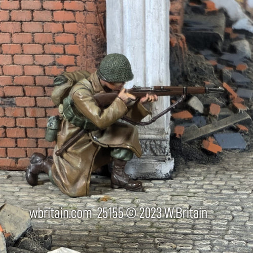 Collectible toy soldier miniature U.S. Infantryman Kneeling Firing in Greatcoat. Soldiers is firing behind brick wall.