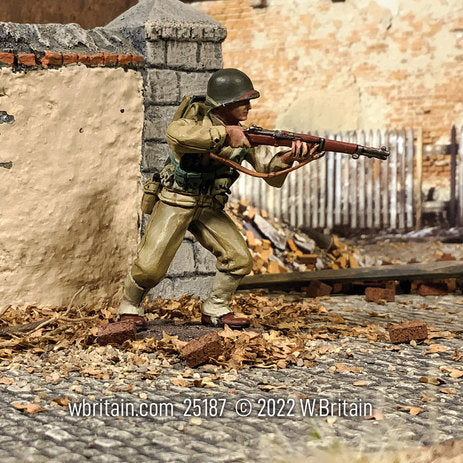 Collectible toy soldier army man U.S. Infantryman Advancing with Caution. He is in a village.