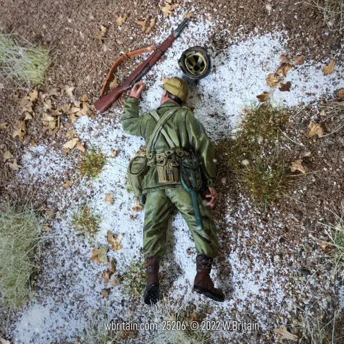 Collectible toy soldier miniature army men casualty. On the battlefield snow.