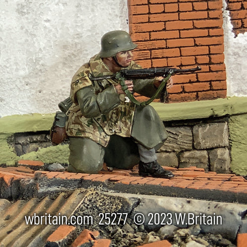 Collectible toy soldier army men German Grenadier Kneeling Firing. He is by a wall.