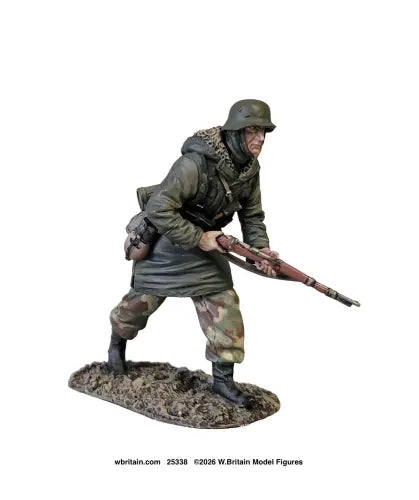 A painted miniature figurine of a World War II soldier in a crouched stance, holding a rifle, mounted on a textured base. The figure is wearing a green military coat, camouflage trousers, and a helmet, set against a plain white background.