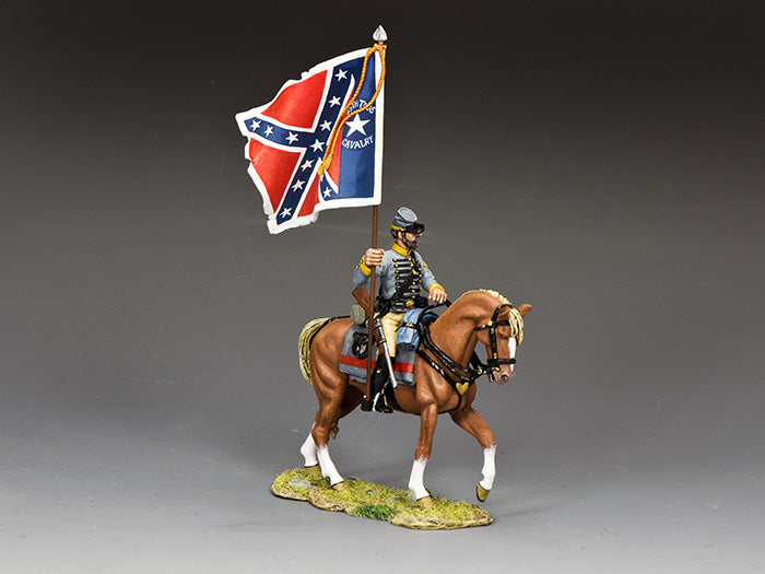 A toy soldier figurine in a Confederate uniform rides a brown horse and holds a Confederate battle flag; the figure is posed on a small grassy base against a plain background.