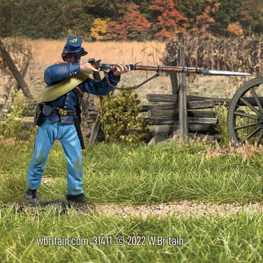 Collectible toy soldier miniature army men Union Corporal in State Jacket Standing Firing. He is on a field.