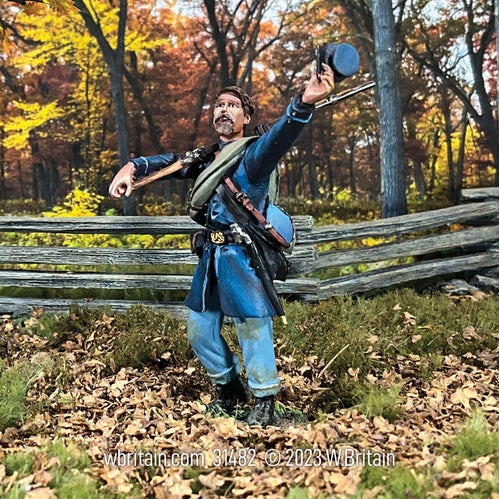 Collectible toy soldier army man Union Infantry in Frock Coat Cheering. He is near a fence.