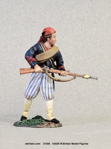 W. Britain Louisiana Tiger advancing with bayonet — Confederate Zouave in red fez, blue jacket, striped trousers. 1/30 scale matte-painted, 1861-62. Catalog 31506.