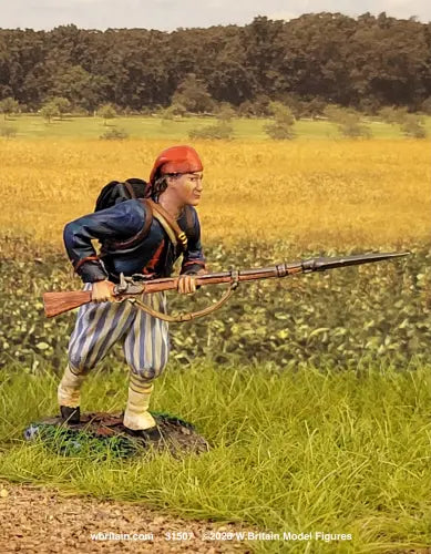W. Britain Louisiana Tiger advancing at the run with bayonet — Confederate Zouave in red fez, blue jacket, striped trousers. 1/30 scale matte-painted, 1861-62. Catalog 31507. Military miniature