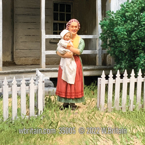 Collectible civilian miniature Rachael Young Woman with Baby. Woman is wearing a red apron.