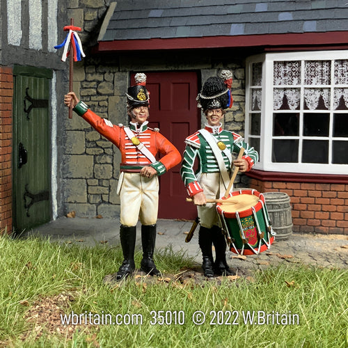 Collectible toy soldier miniature set The King’s Shilling British Recruiting Sergeant and Drummer. They are wearing green and red uniforms.