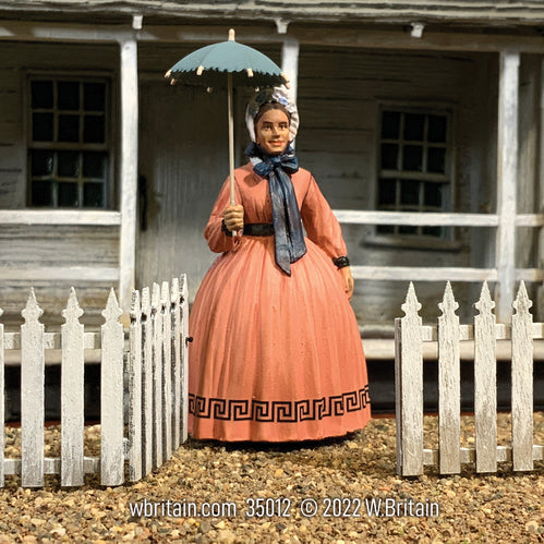 Civilian miniature figurine Miss Hannah, 1860s Woman Out For A Stroll. She is outside.