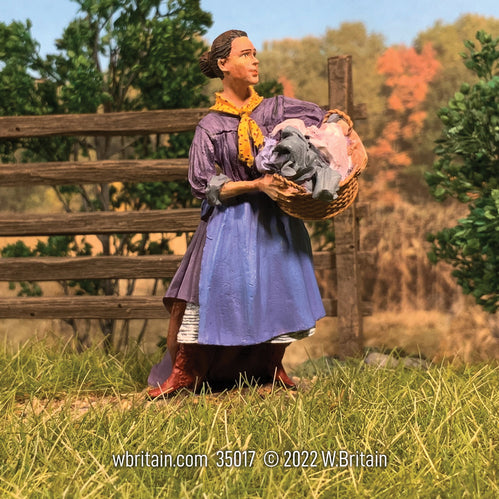 Civilian miniature figurine Miss Alice on Laundry Day. She has a basket.