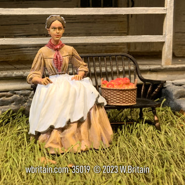 Collectible toy civilian miniature figurine Emily Lost in Thought. She is on a bench.