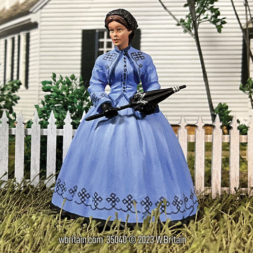 Collectible civilian miniature "Ruth" Young Women in Day Dress. She is in the yard.